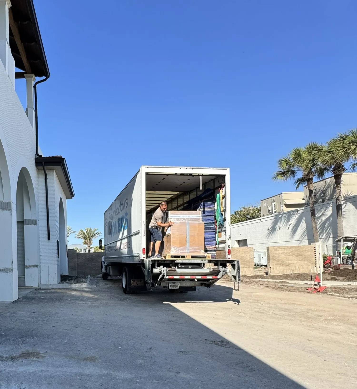 People delivering packages from a moving truck